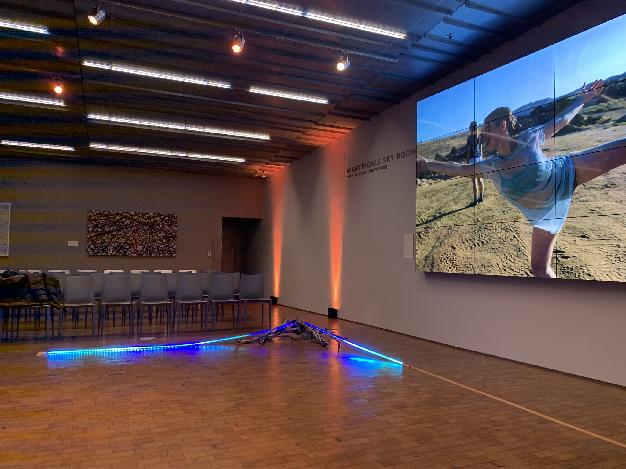 blue and orange lighting alongside video of a dancer